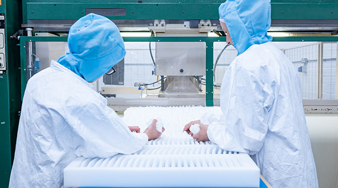 Two AQF employees working in of AQF's ISO Class 8 cleanrooms