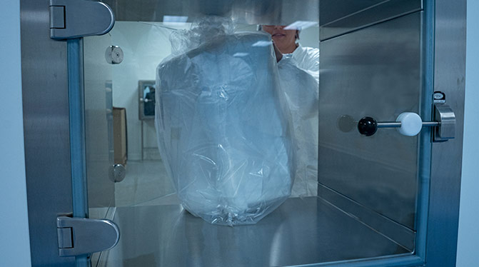 AQF employee in ISO Class 8 cleanroom ensuring that products remain under controlled contamination levels