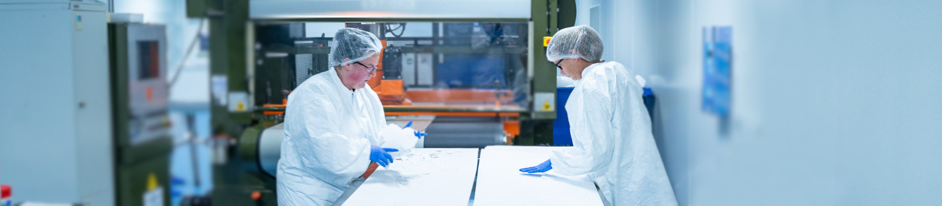 Two AQF Medical staff in AQF's manufacturing and packaging environment which is a ISO Class 8 cleanroom