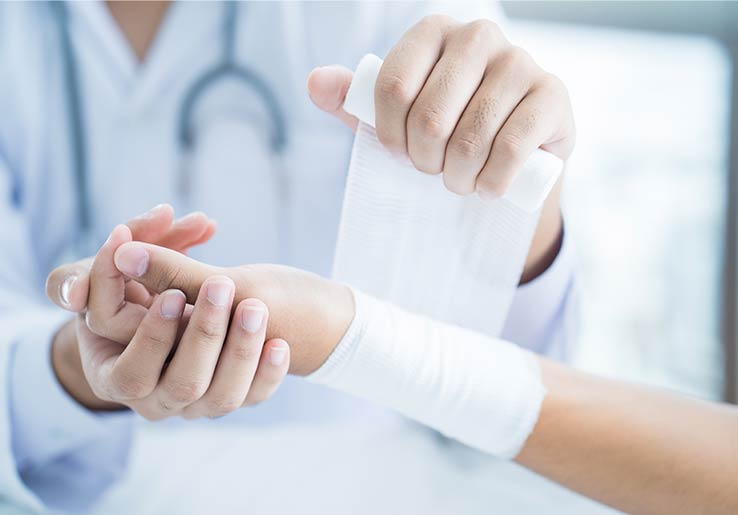 Nurse applying a foam dressing to a patients wound